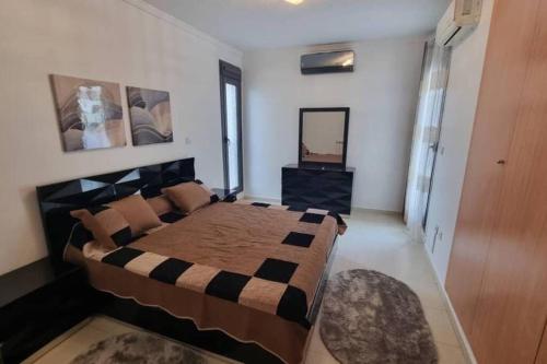 a bedroom with a large bed and a mirror at F5 -5 bedrooms Apt- Residence Hasnaoui avec parking Oran Algeria in Oran