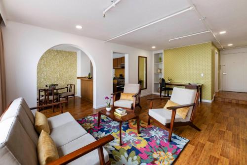 a living room with a couch and a table at Hotel Vilar América in Bogotá