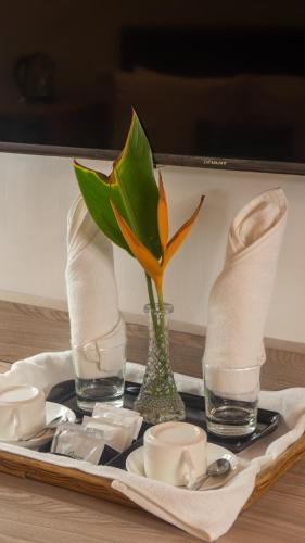 a table with a tray with a flower in a vase at Boracay Sea View Hotel in Boracay