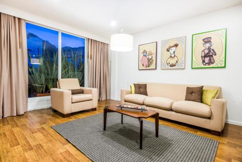 a living room with a couch and a table at Hotel Vilar América in Bogotá