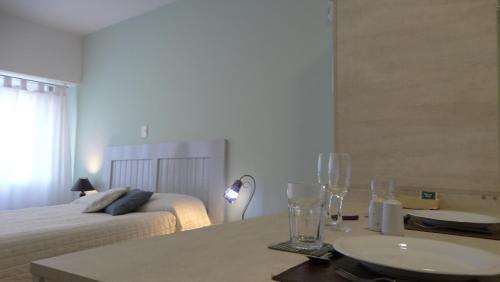 a bedroom with a bed and a table with a sink at Monoambiente en pleno centro de Adrogué in Adrogué