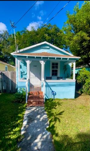 a small blue house with a porch at Key West Style Historic Home in Coconut Grove Florida, The Blue House in Miami