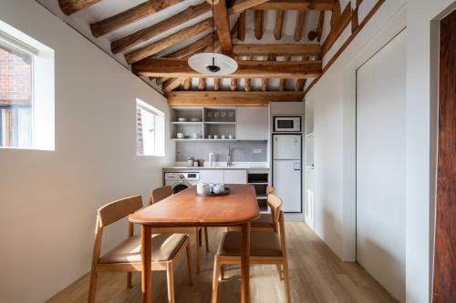 a kitchen and dining room with a wooden table and chairs at Luxury hanok with private bathtub - SN16 in Seoul