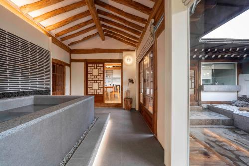a hallway of a house with wooden ceilings at Luxury hanok with private bathtub - SN16 in Seoul