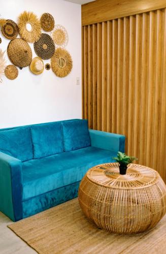 a living room with a blue couch and a table at 3 Peaks Resort & Boutique Hotel in Lipa