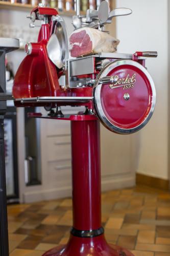 a red scooter is parked on a red pole at Hôtel Ithurria - Teritoria in Aïnhoa