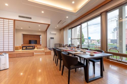 a dining room with a long table and chairs at AOI Sauna SPA & Dog Villa HAKODATE in Hakodate