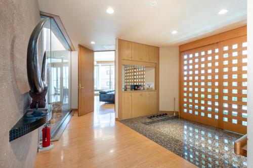 a hallway with a living room with a glass door at AOI Sauna SPA & Dog Villa HAKODATE in Hakodate