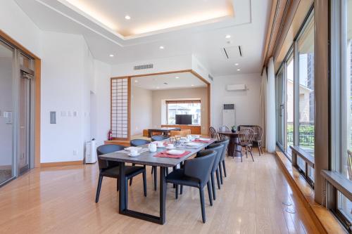 a dining room with a table and chairs at AOI Sauna SPA & Dog Villa HAKODATE in Hakodate
