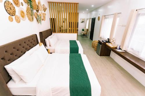 a hotel room with two beds in a room at 3 Peaks Resort & Boutique Hotel in Lipa