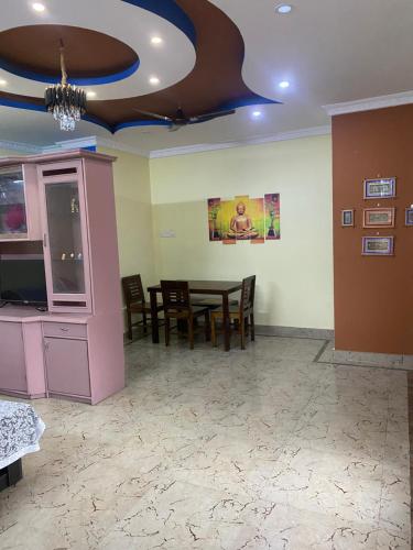 a dining room with a table and chairs and a ceiling at Ghar-fully furnished house with 2 Bedroom hall and kitchen in Bengaluru