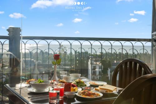 a table with food and a view of the city at Hotel Del Luna Boutique in Da Nang