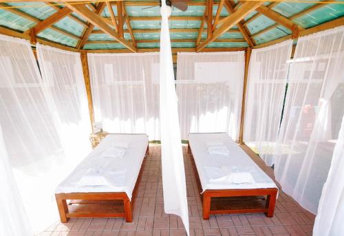 two beds in a room with windows at 3 Peaks Resort & Boutique Hotel in Lipa