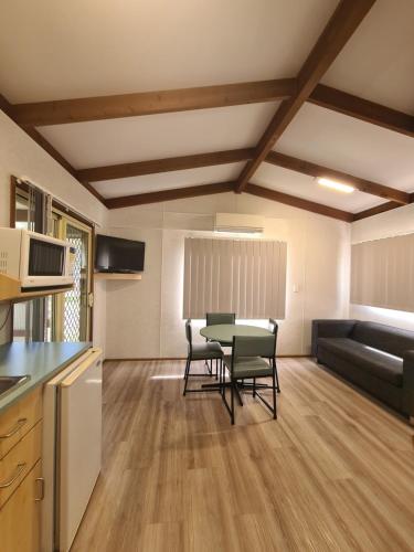 a kitchen and living room with a table and chairs at Island Leisure Village in Bobs Farm