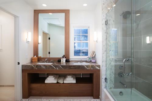 a bathroom with a sink and a shower and a mirror at Carmel Beach Hotel in Carmel