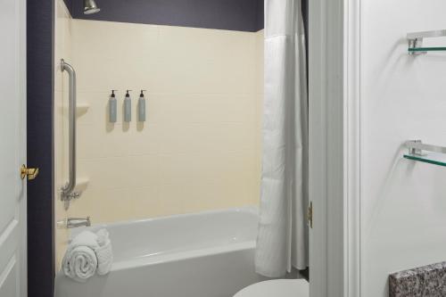 a bathroom with a tub and a toilet and a shower at Residence Inn Manassas Battlefield Park in Manassas