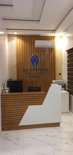 an office with a sign on a wooden wall at Sapphire Residences by Crystal in Ikeja