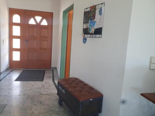 a brown ottoman sitting in front of a door at Ferienhaus Panorama in Rechnitz