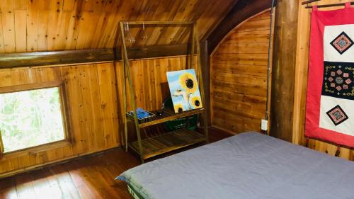 a bedroom with a bed in a wooden cabin at Pea homestay in Sa Pa