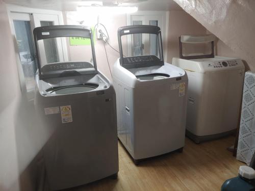 two machines sitting next to each other in a room at T stay guesthouse in Cheongju