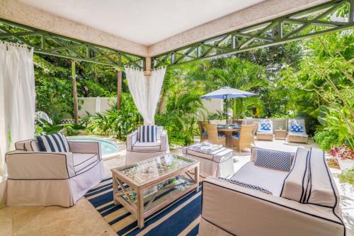 an outdoor patio with chairs and a table at Beacon Hill 202 - Moonshadow by Blue Sky Luxury in Saint Peter