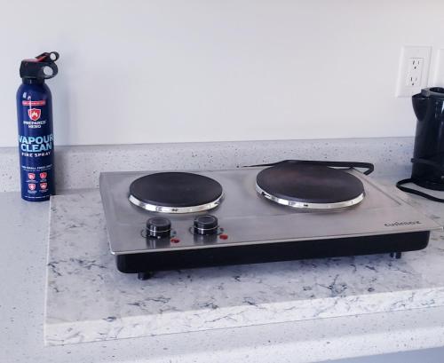 a stove top with two burners on a counter at Peace down the corner in Mission