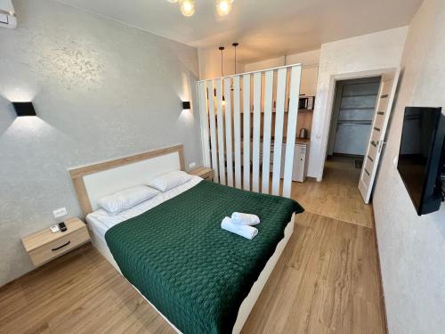 ein kleines Schlafzimmer mit einem Bett und einem TV in der Unterkunft Apartment for you in Iwano-Frankiwsk