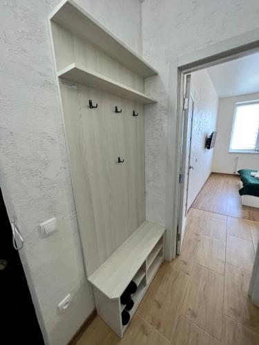 a white room with a bench on the wall at Apartment for you in Ivano-Frankivsʼk