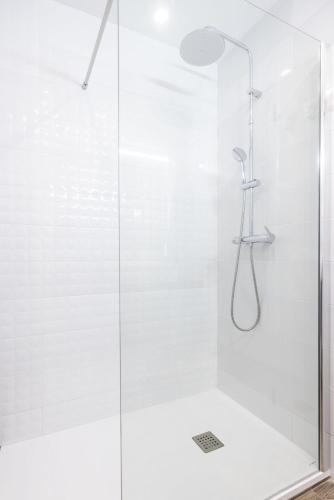 a bathroom with a shower with a glass door at Holy Escape in Santa Cruz