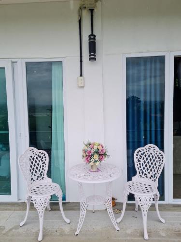 two chairs and a table with a vase of flowers at Before Sunrise Terrace Villa 270° Natural View Chiang Rai in Ban Pa Tung (7)