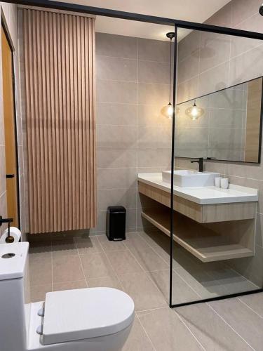 a bathroom with a toilet and a sink at Arau House in Arau