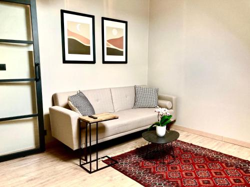 a living room with a couch and a table at Chez Roya in Zaventem