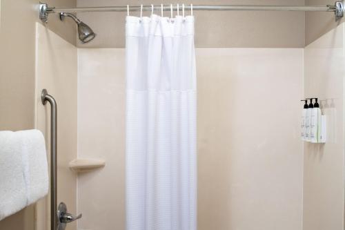 a shower with a white shower curtain in a bathroom at SpringHill Suites by Marriott Charleston Riverview in Charleston