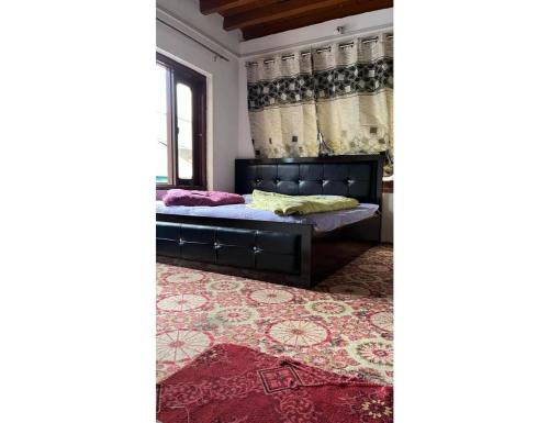 a bedroom with a bed and a rug at Hotel Dayban Resort, Pahalgam in Pahalgām