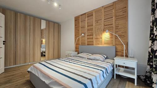 a bedroom with a large bed and a window at Crinului 12 MS in Târgu-Mureş