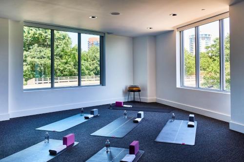 a room with yoga mats in a room with windows at The Casso, Raleigh, a Tribute Portfolio Hotel in Raleigh