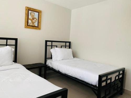 Ein Bett oder Betten in einem Zimmer der Unterkunft Imbasa House - Arusha