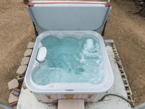 a bath tub sitting on the ground next to a toilet at Sunset Retreat- TWO houses with hot tub, firepit, multiple kitchens, sleeps 20 in Coarsegold