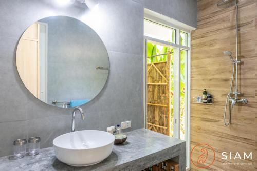 a bathroom with a white sink and a mirror at Villa Sumalee 3Br Private Pool in Koh Samui 