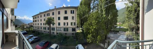 a view of a building with cars parked in a parking lot at Residenza Basilica in Tirano