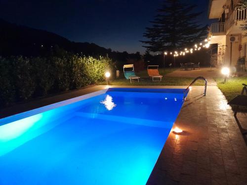 a swimming pool at night with blue lights at Oasi naturale "Roscignola" in SantʼOnofrio