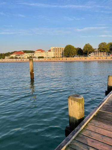 a body of water with two wooden posts in the water at Penthaus Horizont mit Meerblick in Lübeck