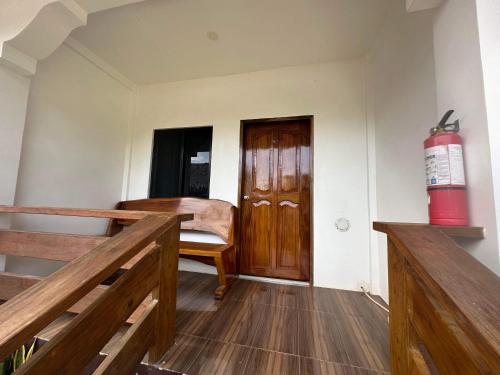 a room with a wooden door and a fire extinguisher at Room 1 Family Fuego Island Guest House By Fuego Island Private Resorts in San Juan