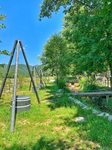 a park with an empty swing set in the grass at Cabana A Vaideeni in Vaideeni