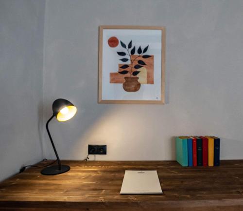 a desk with a lamp and books on it at Hameau Mukhrani in Mukhrani