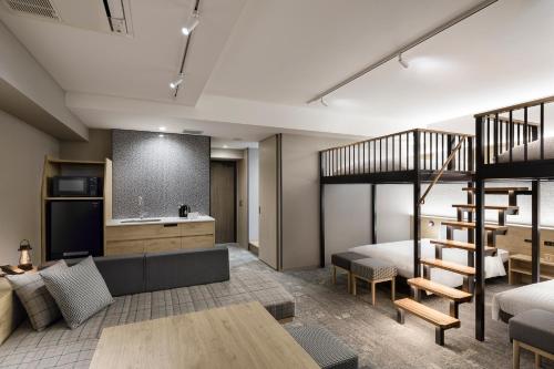a living room with a loft bed and a kitchen at Tokyu Stay Shibuya in Tokyo