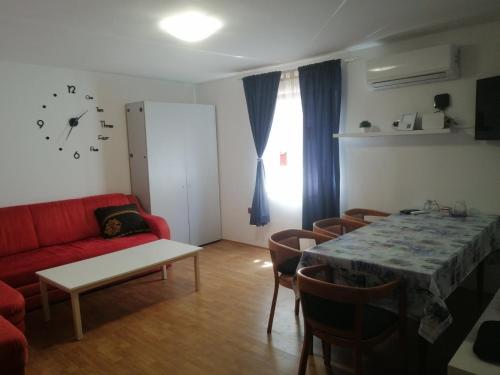 - un salon avec un canapé rouge et une table dans l'établissement Kuća Melita -jacuzzi, à Kastav