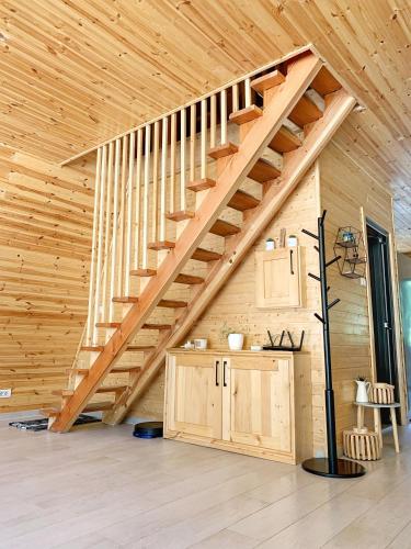 a staircase in a room with a wooden ceiling at Cabana A Vaideeni in Vaideeni