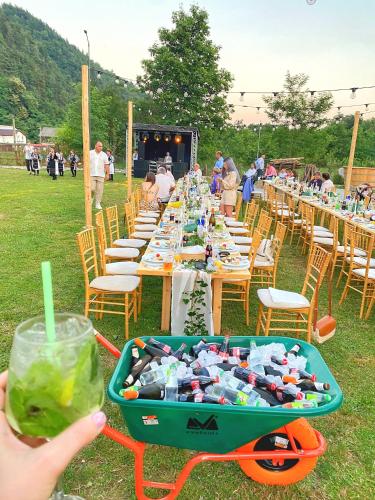 a long table with a cart full of bottles at Cabana A Vaideeni in Vaideeni