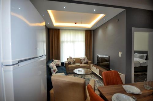 a living room with a couch and a table at Arpaçay Apart Otel in Kars